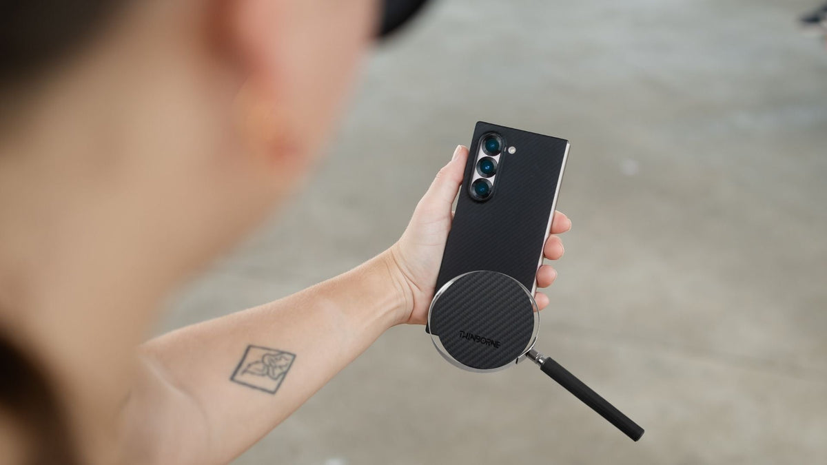 arm with tattoo holding a foldable android phone aramid fiber thin case