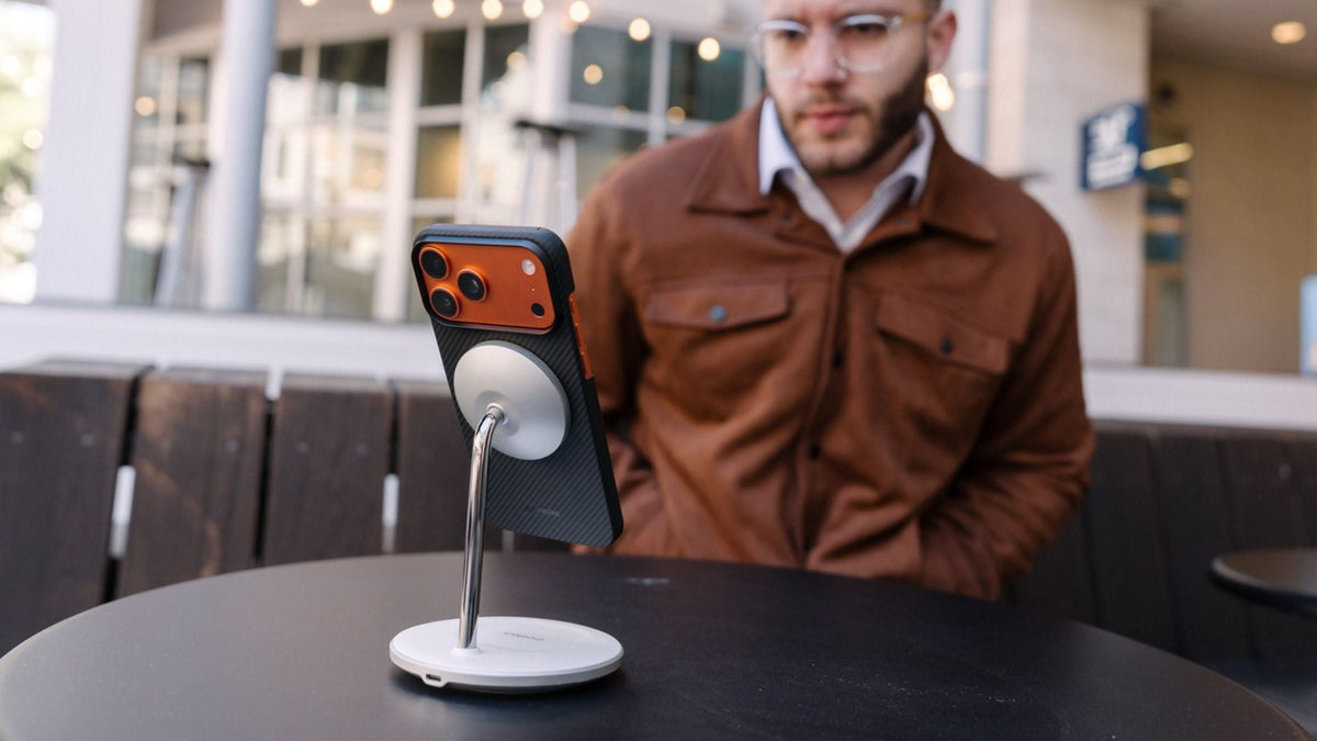 A smartphone attached to a magnetic charging stand demonstrates how magnetic accessories work safely with modern phones
