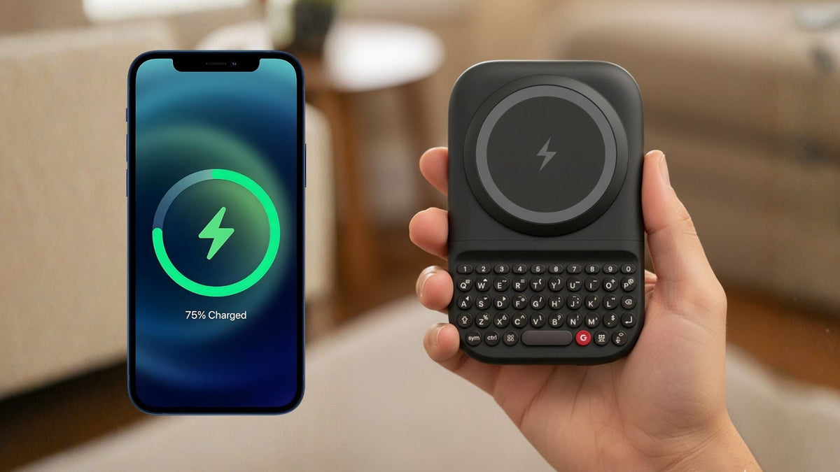 Smartphone showing charging status beside a hand holding the Clicks Power Keyboard