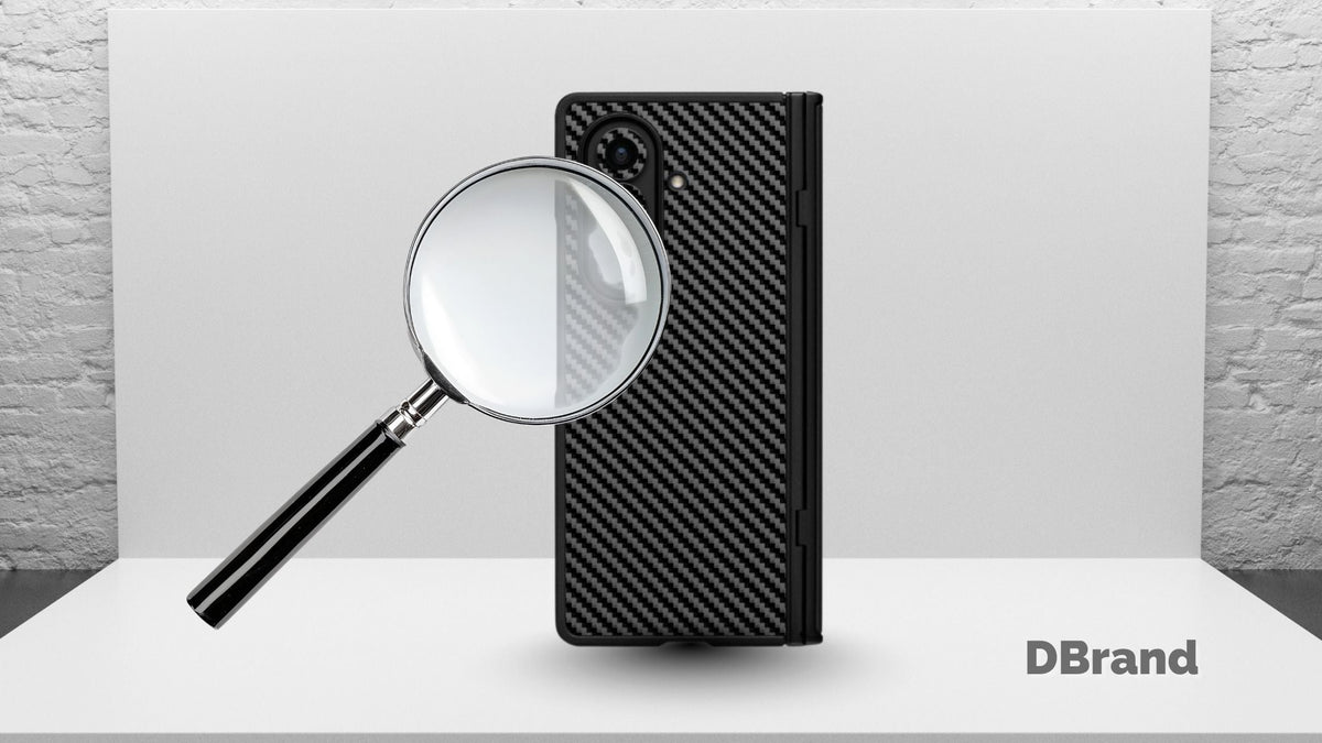 Magnifying glass on DBrand Galaxy Z Fold 7 case on grayish background