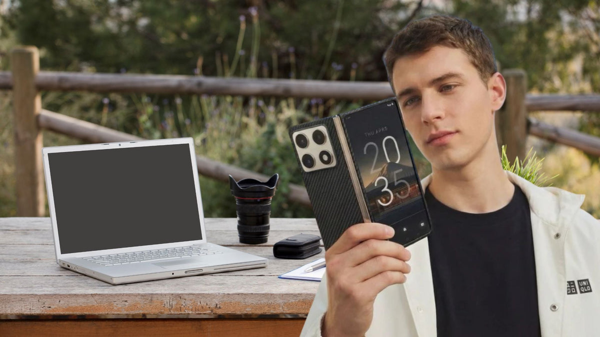 outdoor photo showing computer and work setup with a man holding motorola razr fold 2026