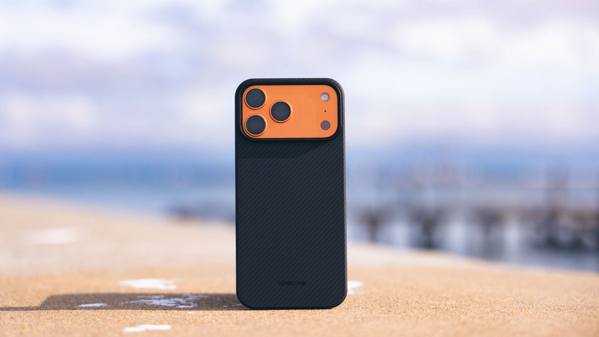 ThinBorne iPhone 17 Pro Max case standing on a sandy surface outdoors 