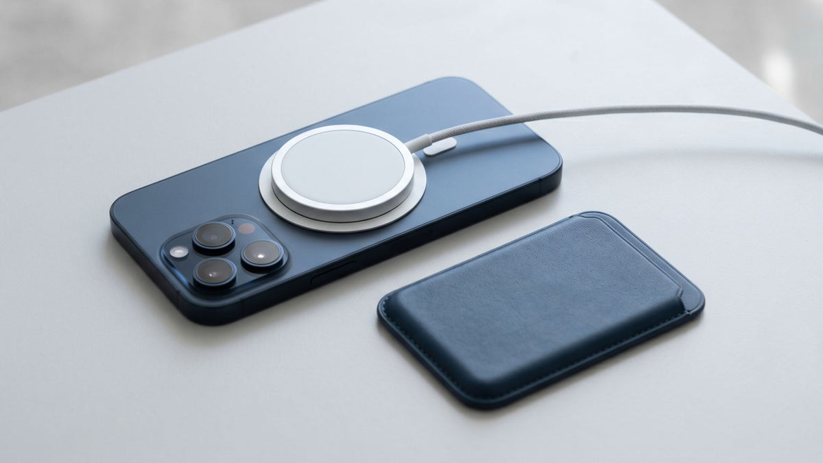 iPhone in MagSafe case with magnetic charger attached beside MagSafe wallet