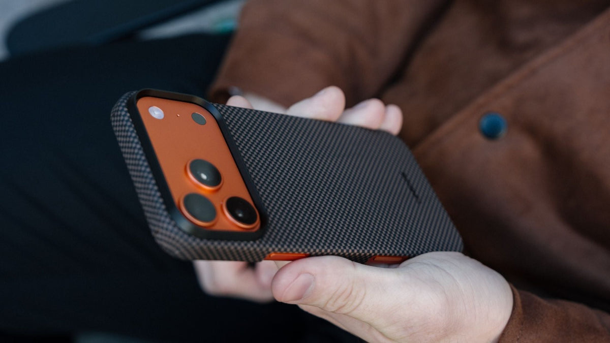 Hand holding iPhone 17 Pro in black Thinborne aramid fiber case