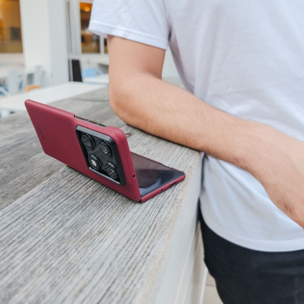 motorola razr fold with case sitting on a surface near a man's arm