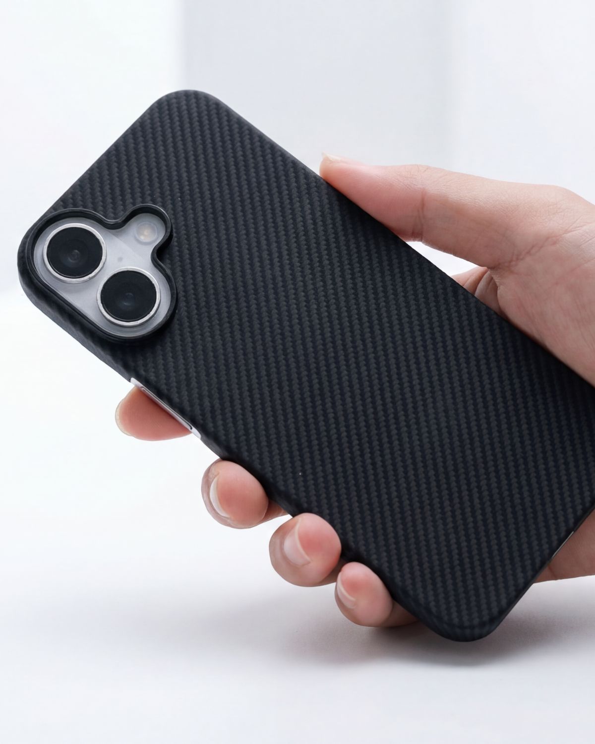 Hand holding a black textured iphone 17 case on a white background