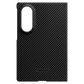 A black carbon fiber samsung galaxy z fold 8 phone case with a circular camera cutout and the Thinborne logo at the bottom, shown against a solid green background.