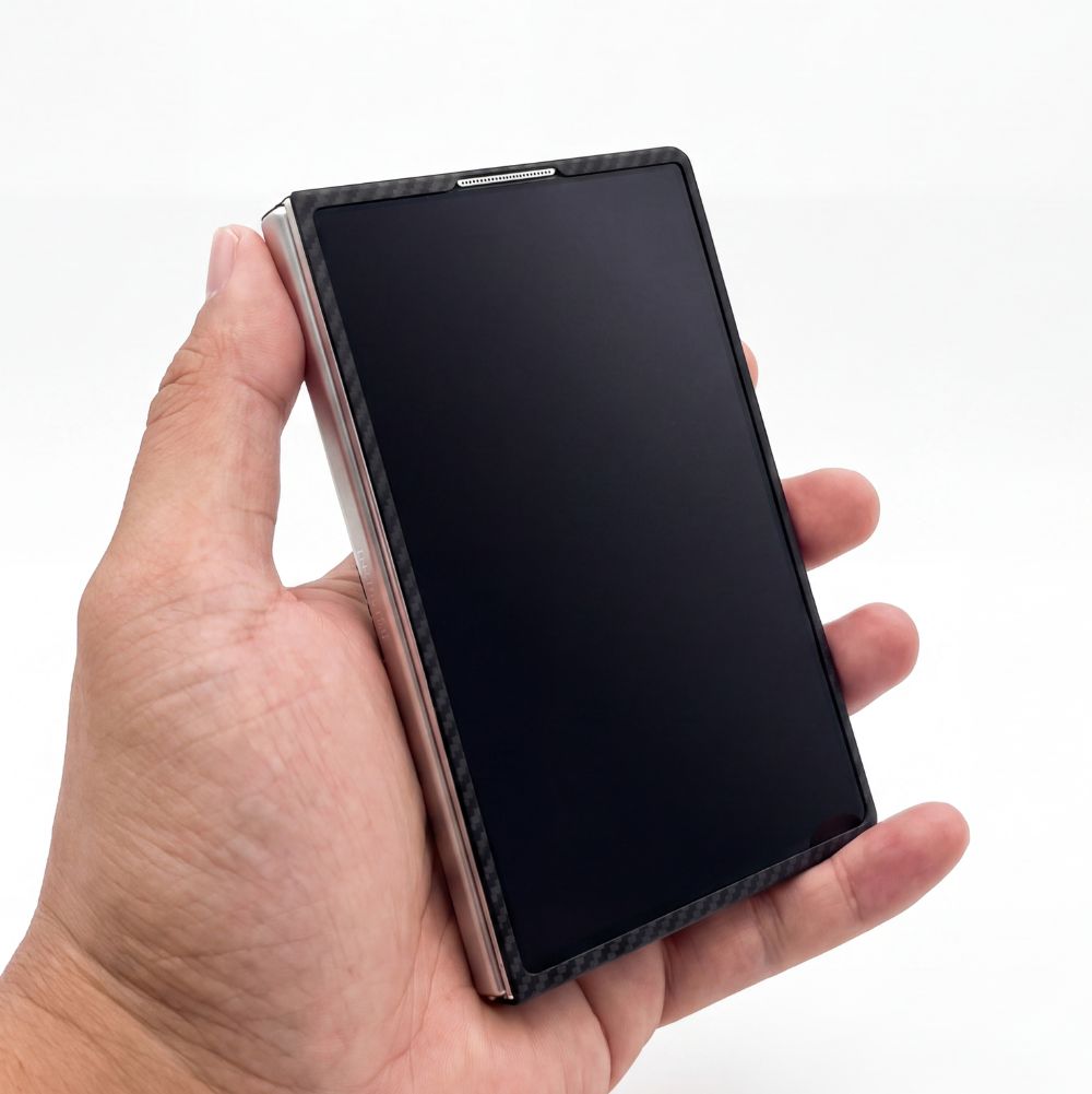 a hand holding galaxy z fold 8 with aramid fiber case