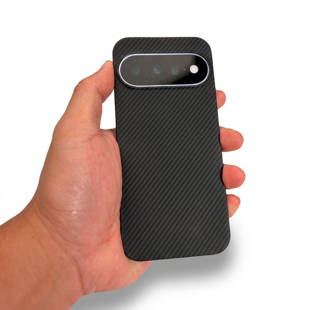 A hand holding a black carbon fiber pixel 11 phone case with a camera cutout, shown against a plain white background.