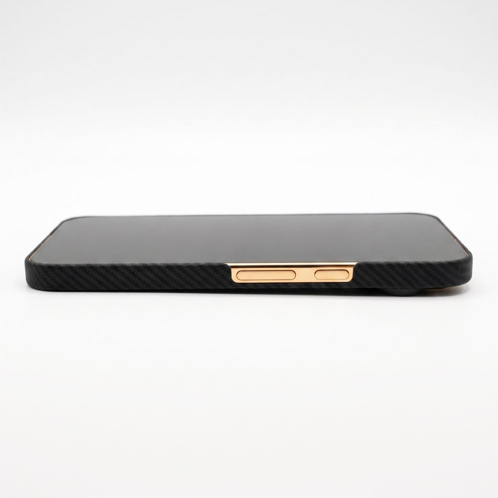 A black carbon fiber pixel 11 pro xl  phone case with rose gold metal button accents, shown from the side on a white background.