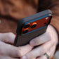Person holding a phone with a textured iPhone 17 pro max case, blurred background