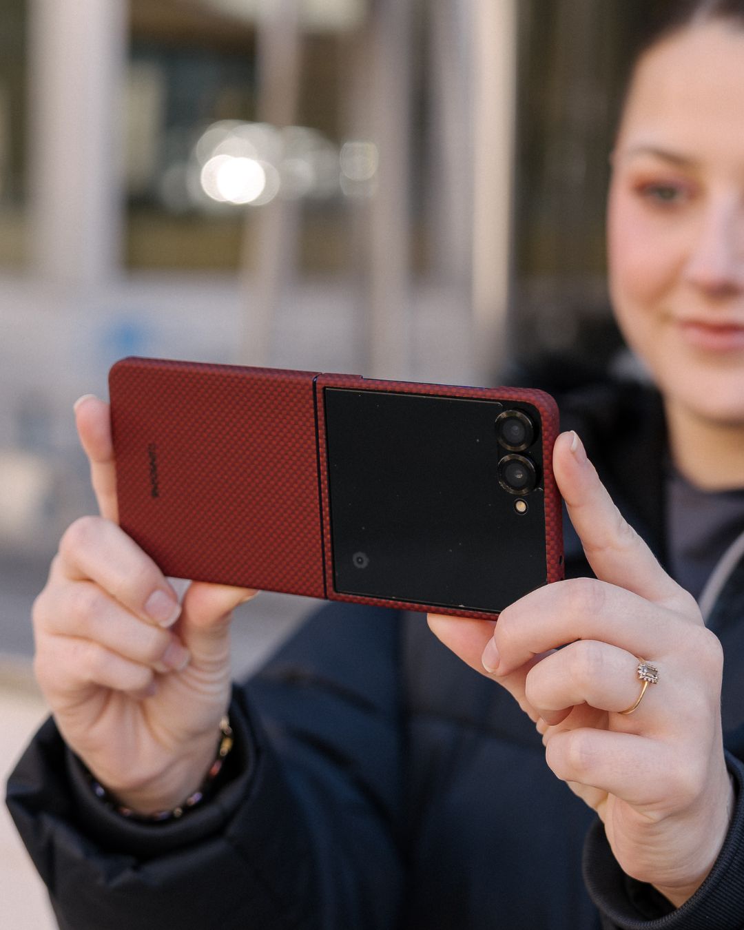 a lady holding galaxy z flip 7 with aramid fiber case horizontally to take photos
