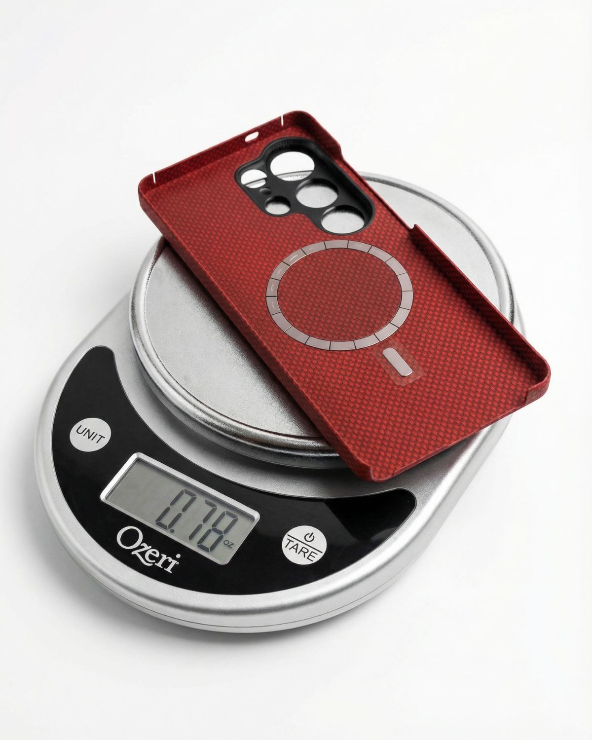 Red samsung galaxy s26 ultra case on a digital kitchen scale displaying weight 0.76 oz
