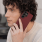 Man holding a red samsung s26 ultra case case with a blurred background