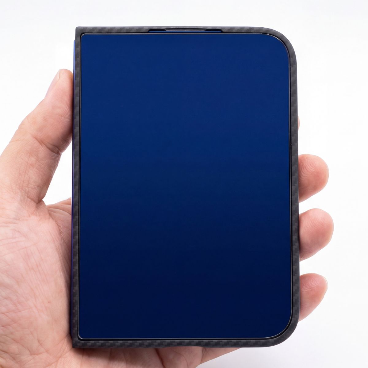 A hand holding a iPHONE DUO with a dark blue screen protector and a black carbon fiber textured bumper frame, shown against a plain white background.