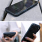 A composite image showing a black iPhone case from three angles: a close-up of the phone lying on a concrete surface, a side view while held in hand, and a rear view showing the cameras.