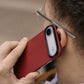 Person holding a red iphone air case to their ear