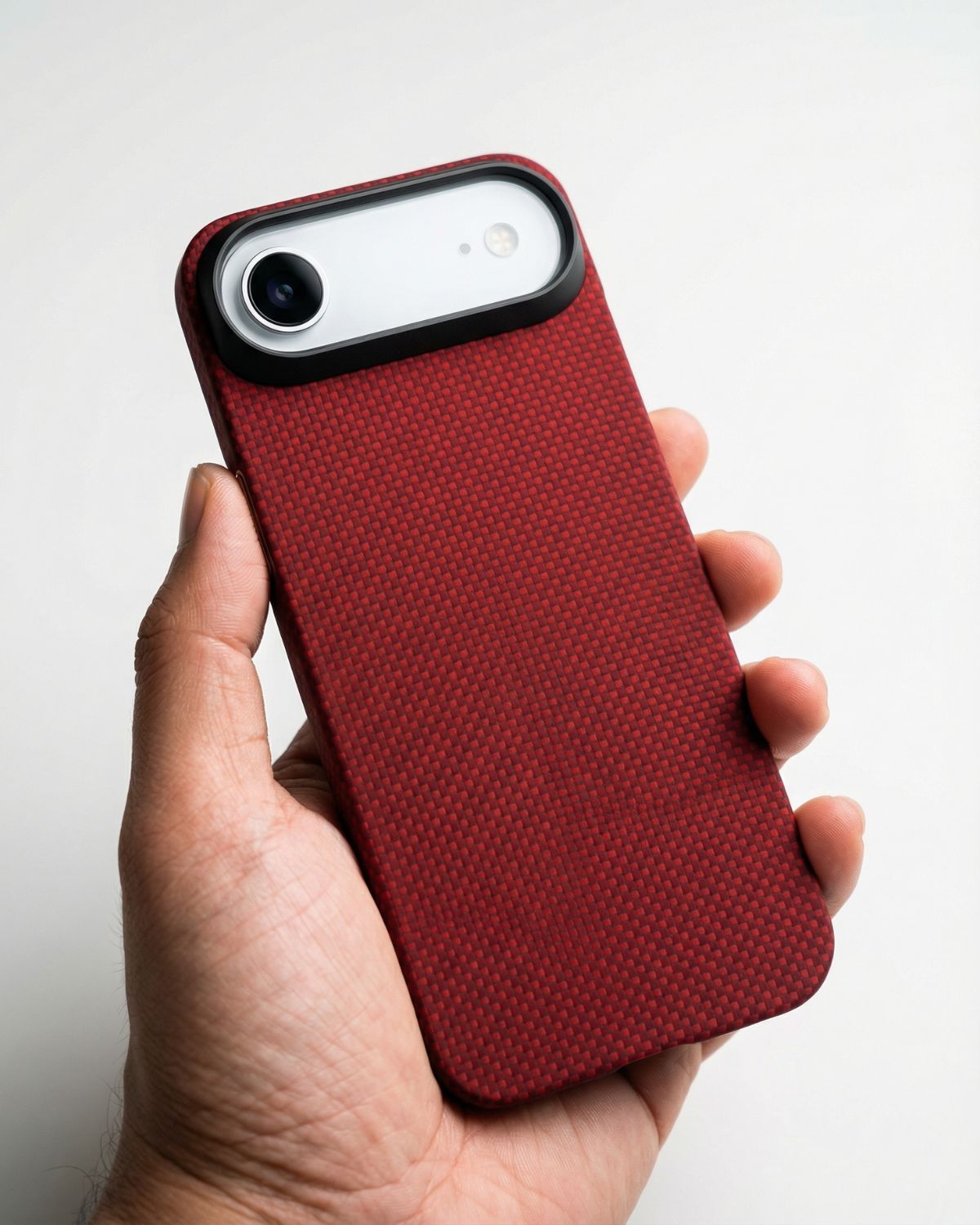 Red textured iphone air case held in a hand against a white background