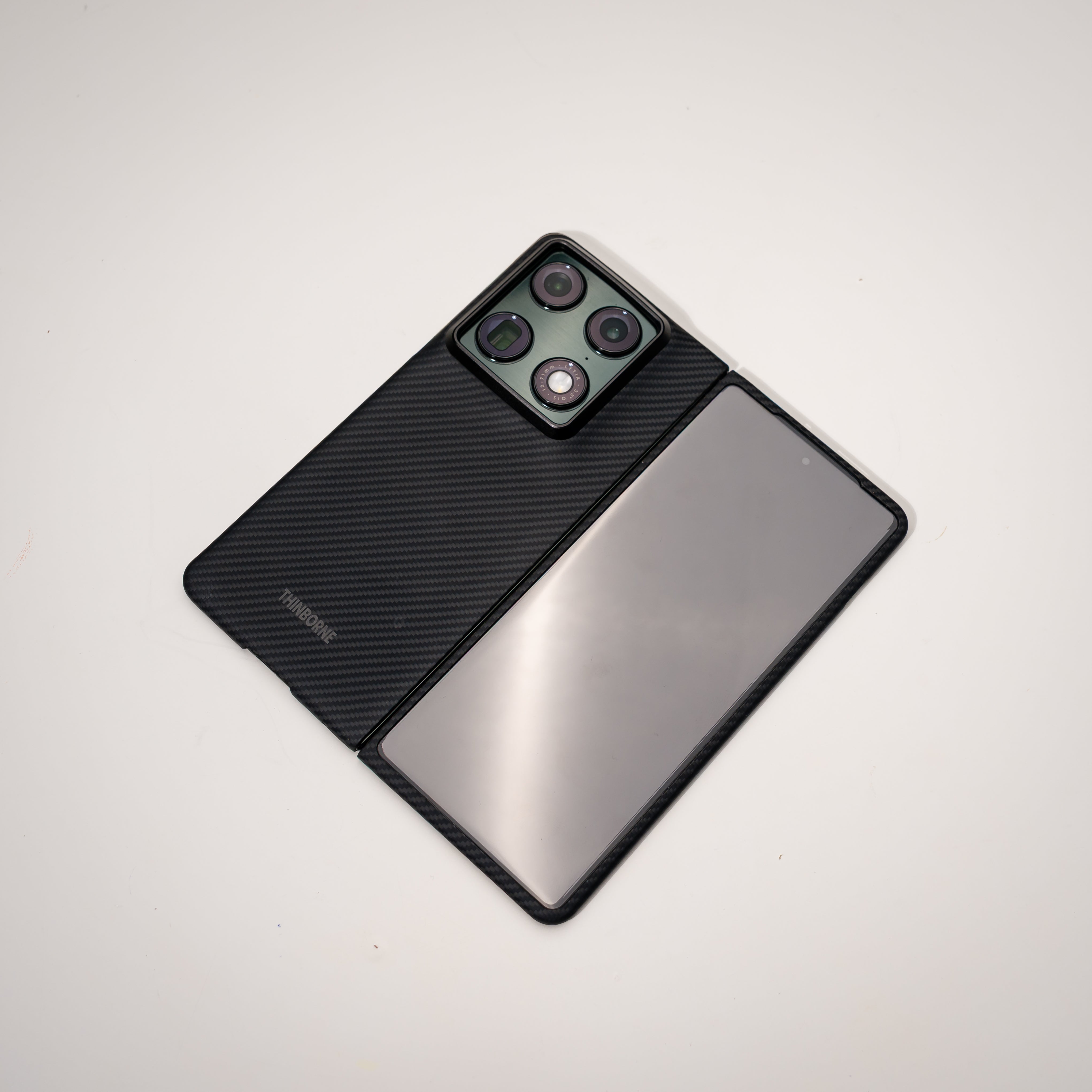 razr fold Phone case with textured black back and reflective silver front on a light gray background