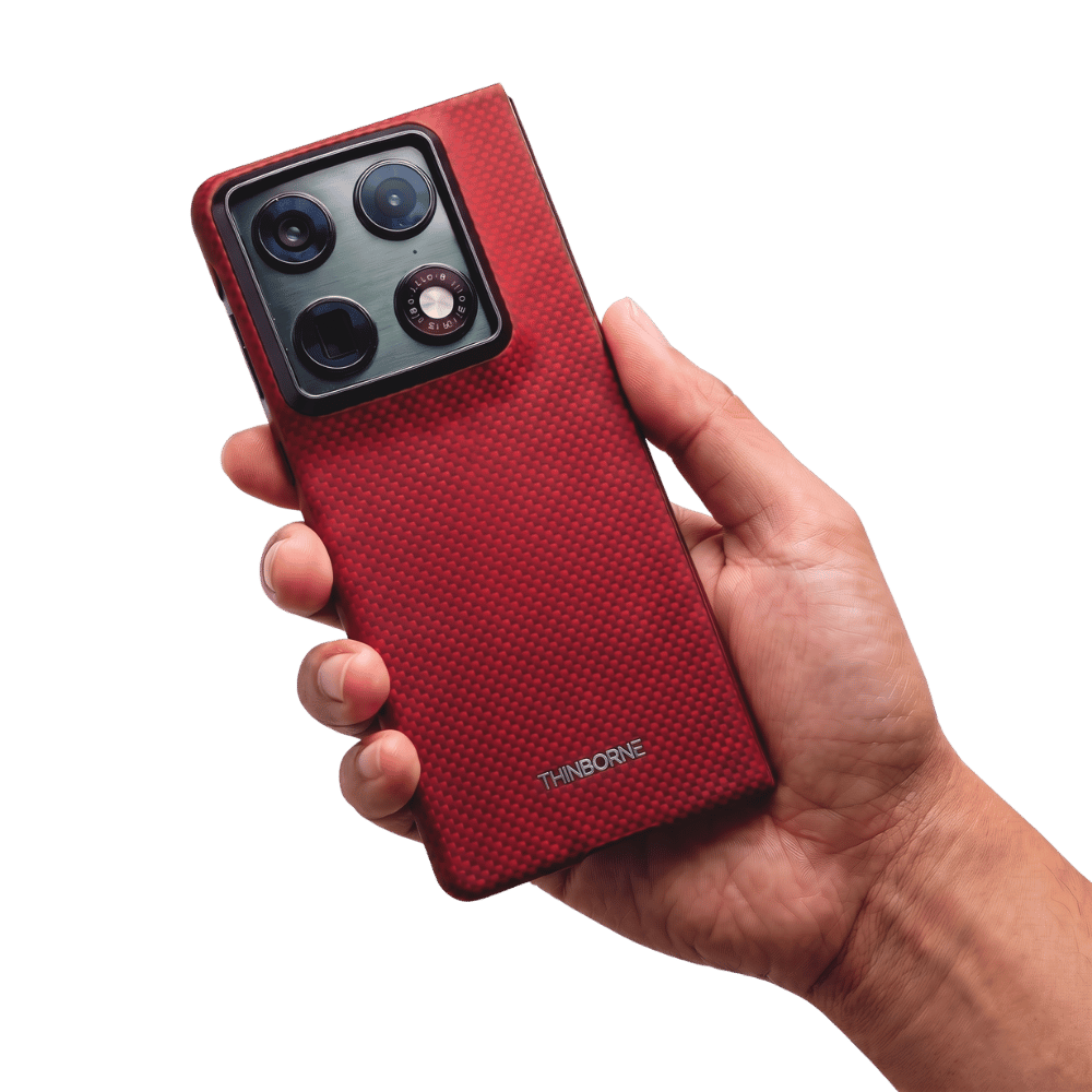 Hand holding a red aramid fiber motorola razr fold phone case with a clear background