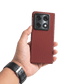 Hand holding a red aramid fiber motorola razr fold phone case with a clear background