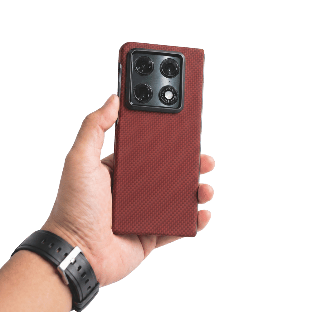 Hand holding a red aramid fiber motorola razr fold phone case with a clear background