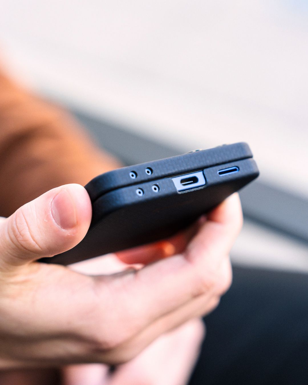 showing the bottom of galaxy z flip 7 navy case that held by a hand