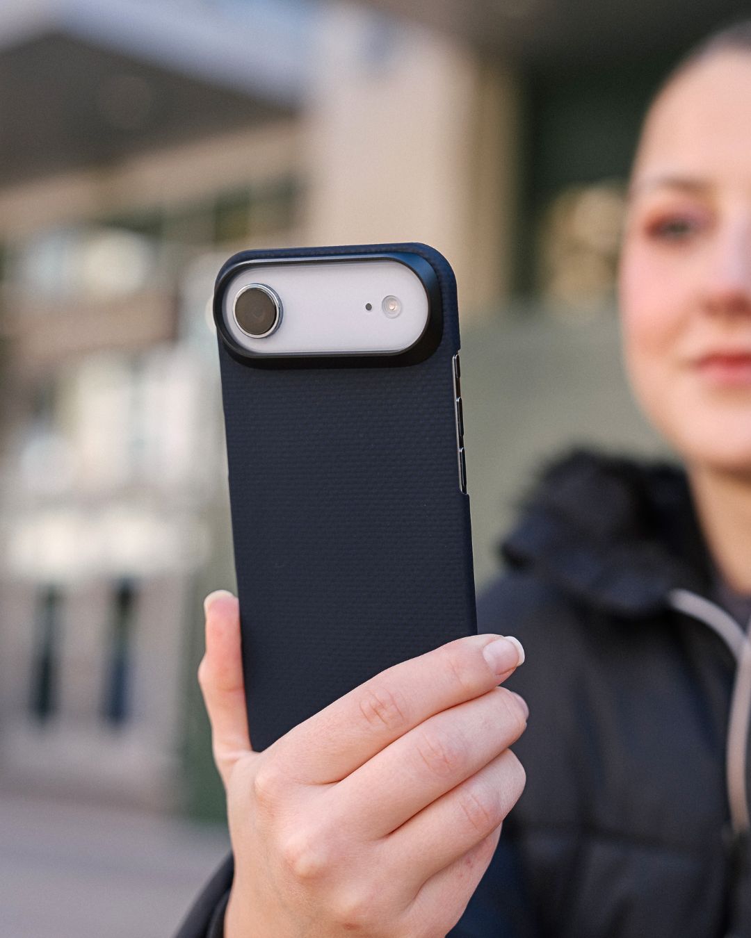 Person holding a navy iphone air
 phone case outdoors