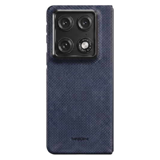 Navy motorola razr fold case with carbon fiber texture on a green background