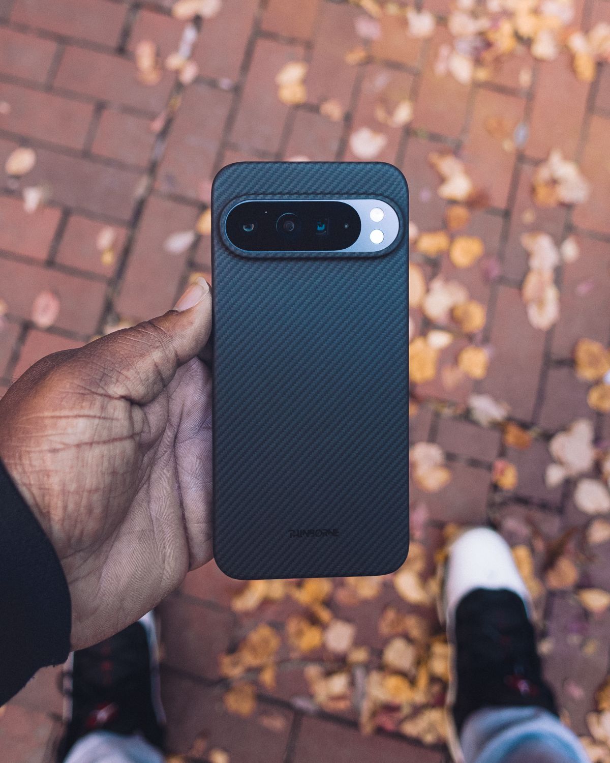 Pixel 10 Pro XL case in hand, slim carbon fiber design.