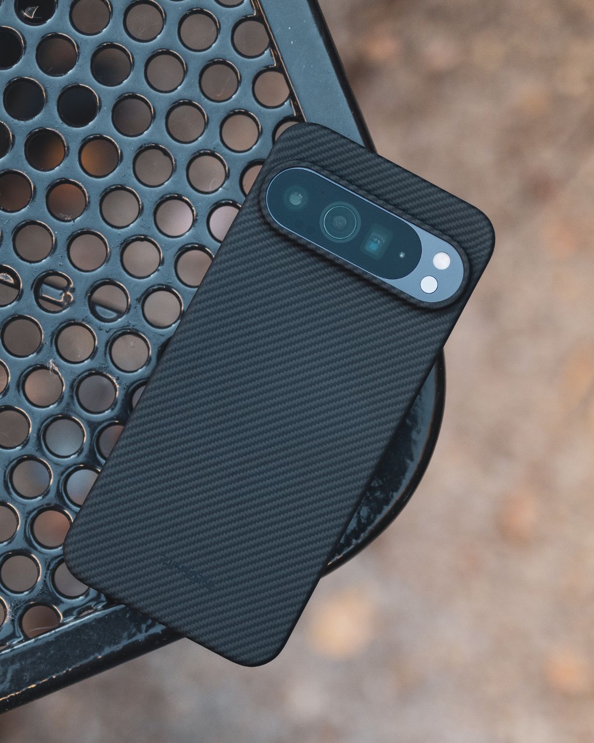 Pixel 10 Pro XL case on metal bench, premium aramid texture.
