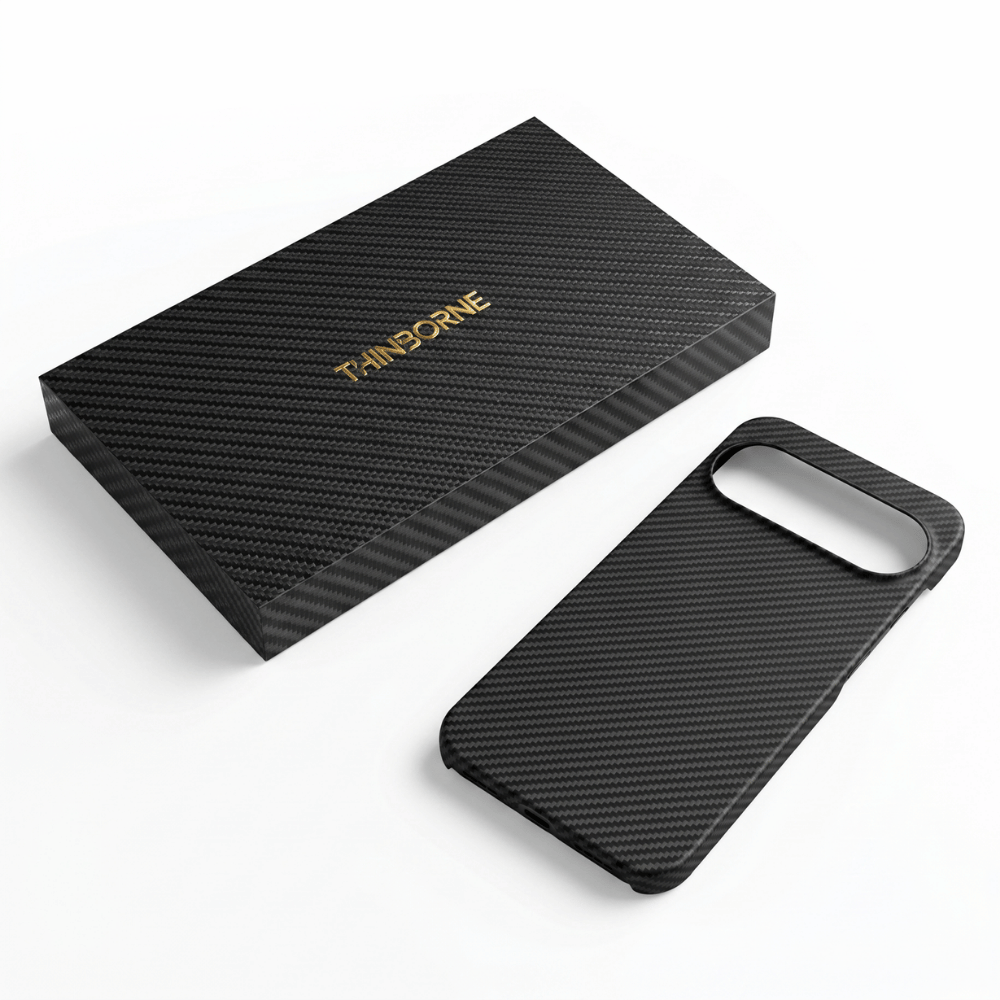 A black carbon fiber pixel 11  phone case shown next to its matching black presentation box with gold 'thinborne' branding, on a clean white background.