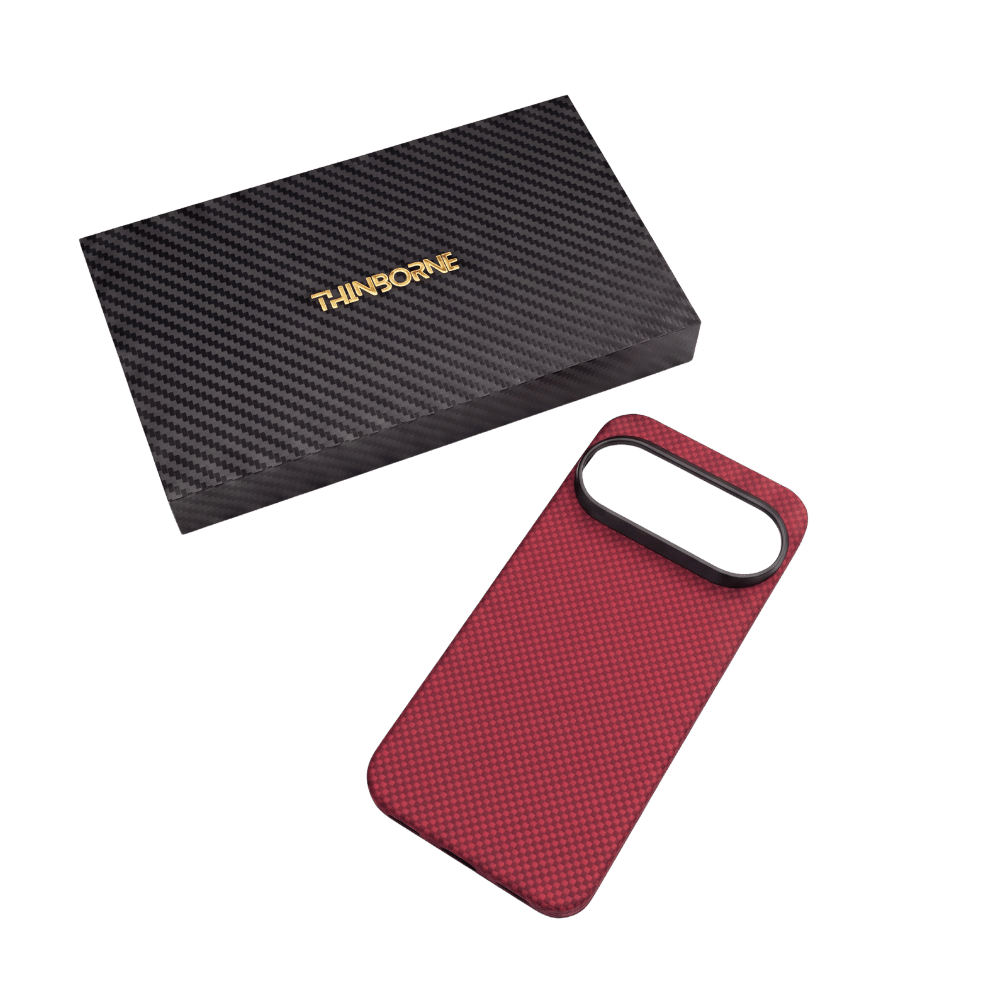 A red textured PIXEL 11 PRO case with a black camera bumper, shown next to its black carbon-fiber-patterned THINSBORNE box on a solid green background.